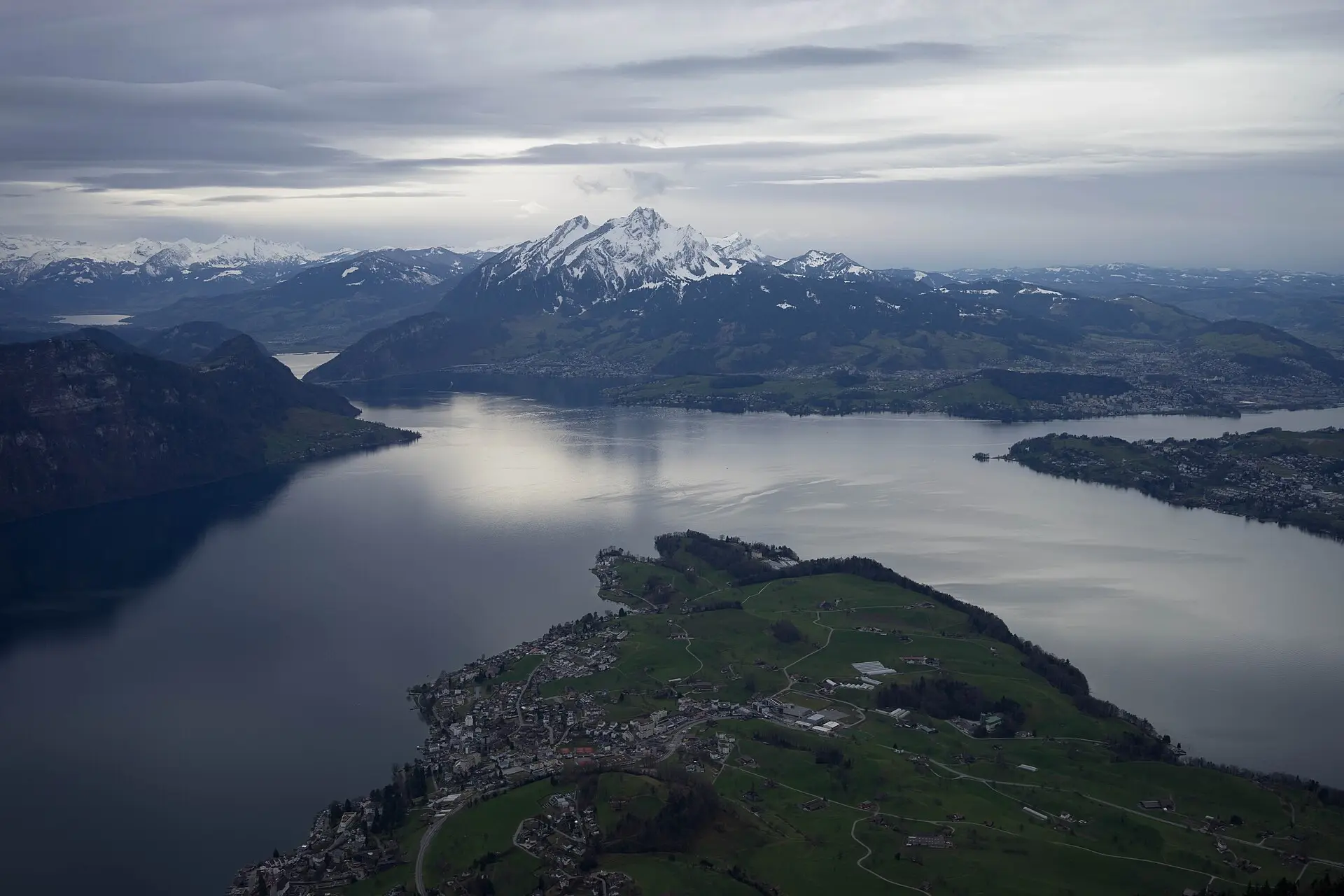 Alpine lake below snow-capped peaks in the Swiss Alps